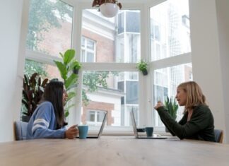 Unlocking Online Growth: How to Connect with the Right B2B Marketing Consultant woman in black long sleeve shirt sitting beside woman in blue long sleeve shirt