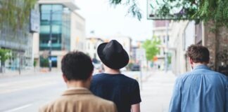three men walking along the street