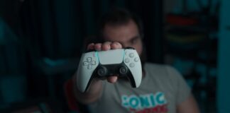 boy in gray and red crew neck t-shirt holding gray game controller