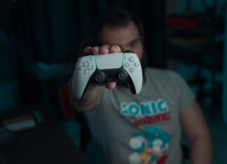 Madden 24 Game | How to Make Strongest Fanbase boy in gray and red crew neck t-shirt holding gray game controller