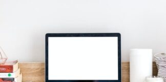 turned-on MacBook on desk