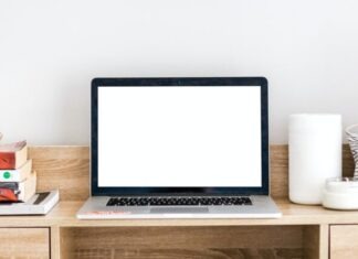 turned-on MacBook on desk