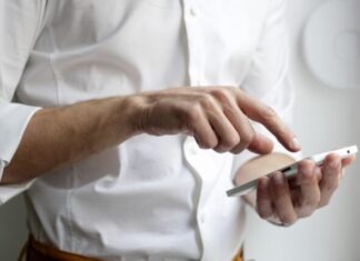 person holding white Android smartphone in white shirt
