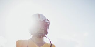 man wearing yellow jersey shirt and white helmet