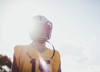 The Holistic Impact of SARM Medication on Players’ Physical and Mental Well-Being man wearing yellow jersey shirt and white helmet