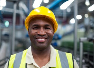 What Happens if I Don’t Have Workers’ Comp Insurance Florida? Portrait of smiling factory worker in the factory