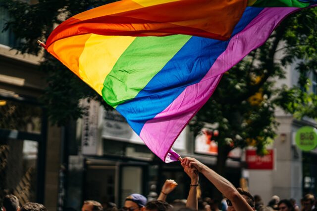 Photo by Raphael Renter people holding flags during daytime