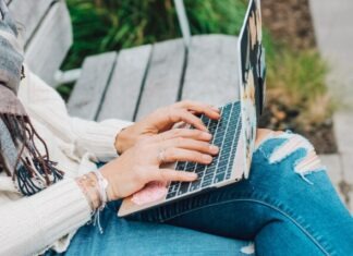 From Guilt to Growth: Exploring Emotional Resilience Through Ashley Madison person in white long sleeve shirt and blue denim jeans using macbook pro