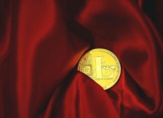 Cryptocurrency Tax Strategies: Maximizing Returns and Minimizing Liabilities a close up of a gold coin on a red cloth