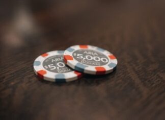 An Introduction to Mega888 -The Ultimate Online Casino Experience two poker chips sitting on top of a wooden table