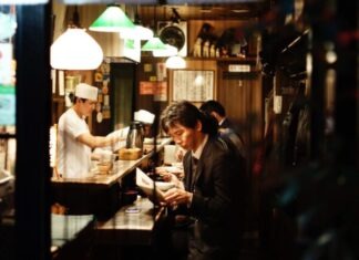 6 Tips for Planning Your Own Culinary Tour of Tokyo man holding menu