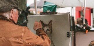 man painting cat
