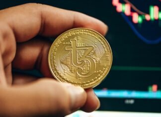 The Best Automated Crypto Trading Platform in 2023: Trade Cryptocurrencies with Ease a hand holding a gold bitcoin in front of a stock chart