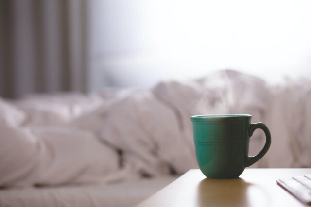 Photo by David Mao green ceramic mug on wooden desk