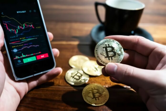 Photo by Wance Paleri a person holding a bitcoin next to a cup of coffee