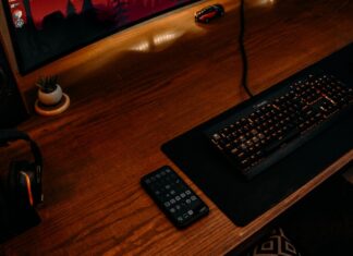 black computer keyboard on brown wooden desk