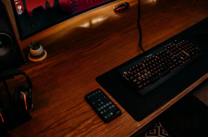 Photo by Amr Taha™ black computer keyboard on brown wooden desk
