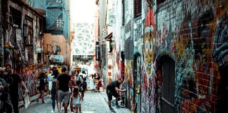 man and girl walking beside building