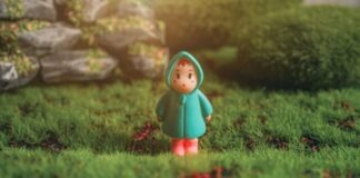 red haired girl in green dress figurine on green grass during daytime