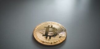 gold round coin on gray surface