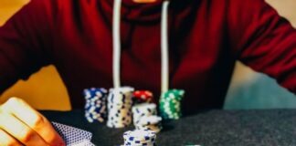 person sitting near poker chips