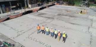 seven people standing on rooftop