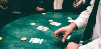 A person playing poker on a green table Description automatically generated