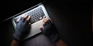 person in black long sleeve shirt using macbook pro