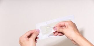 person holding white printer paper