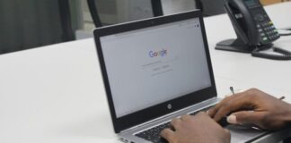 person typing on gray and black HP laptop