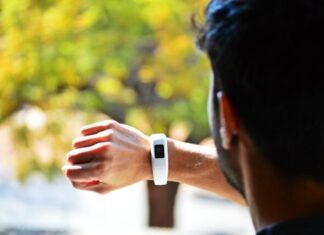 The Future of Wearable Technology: A Closer Look at the Gadgets and Innovations man looking at activity tracker