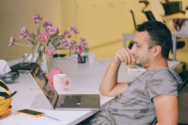 Photo by Lala Azizli man in gray crew neck t-shirt using macbook pro