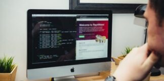 silver imac on brown wooden desk