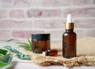 brown glass bottle on brown textile