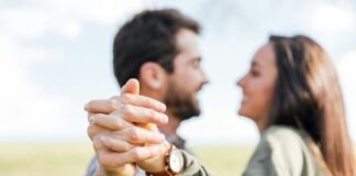 man in gray long sleeve shirt holding womans hand