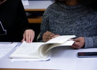GMAT Preparation – A Comprehensive Guide to Ace the Exam woman flipping book page