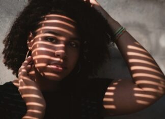 Representation Matters: Celebrating Diversity in Camming Through Ebony Performers shadow of window on woman's face
