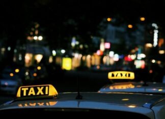Safe Travels Under Neon Lights: Ensuring Your Taxi Ride in Las Vegas is Secure shallow focus photography of Taxi signage
