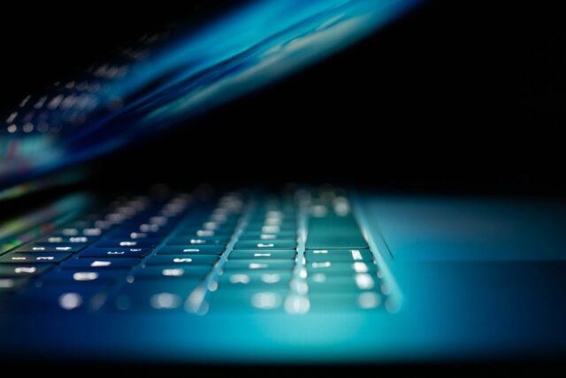 Photo by Philipp Katzenberger closeup photo of turned-on blue and white laptop computer