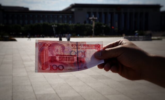 Photo by Bernd ð· Dittrich a person holding a piece of paper with a picture of a building in the background