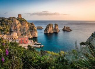 photo of house near cliff and body of water