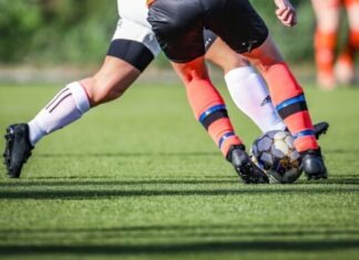 Players To Look Out For At The Euros 2024 woman in black and white soccer jersey kicking soccer ball on green field during daytime
