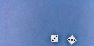 white and black dice on blue textile