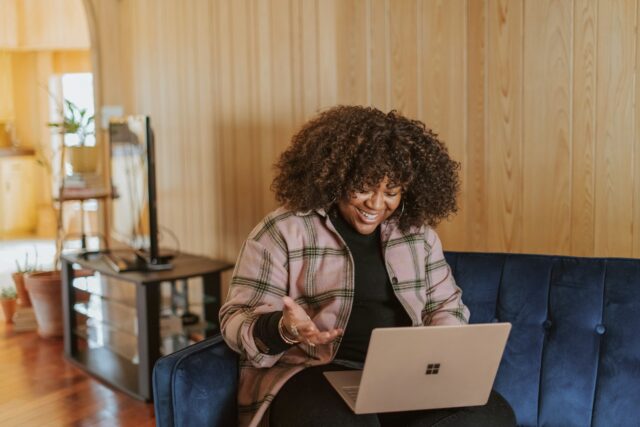 Photo by Surface person sitting on couch holding a Surface device