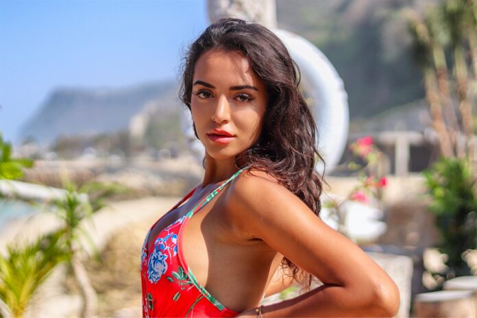 Photo by Jernej Graj woman in red and white floral tank top