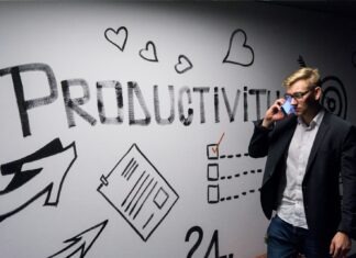 How Owners Stay Legal: Top Tips for Busy Managers man holding smartphone looking at productivity wall decor