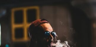 man in white crew neck shirt wearing black sunglasses