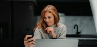 a woman sitting in front of a laptop computer