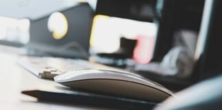 black and yellow computer mouse on white desk