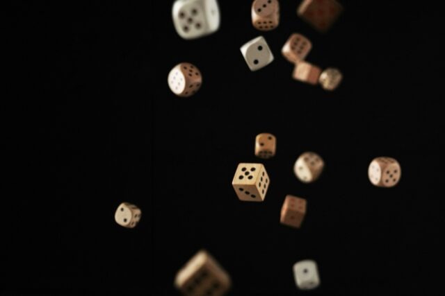 Photo by Jonathan Greenaway a group of dices flying in the air